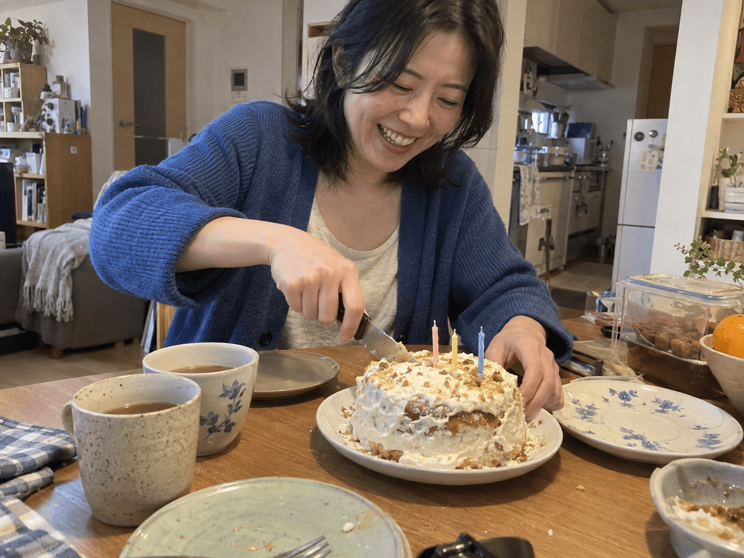A homemade cake and mismatched plates at an ordinary gathering.