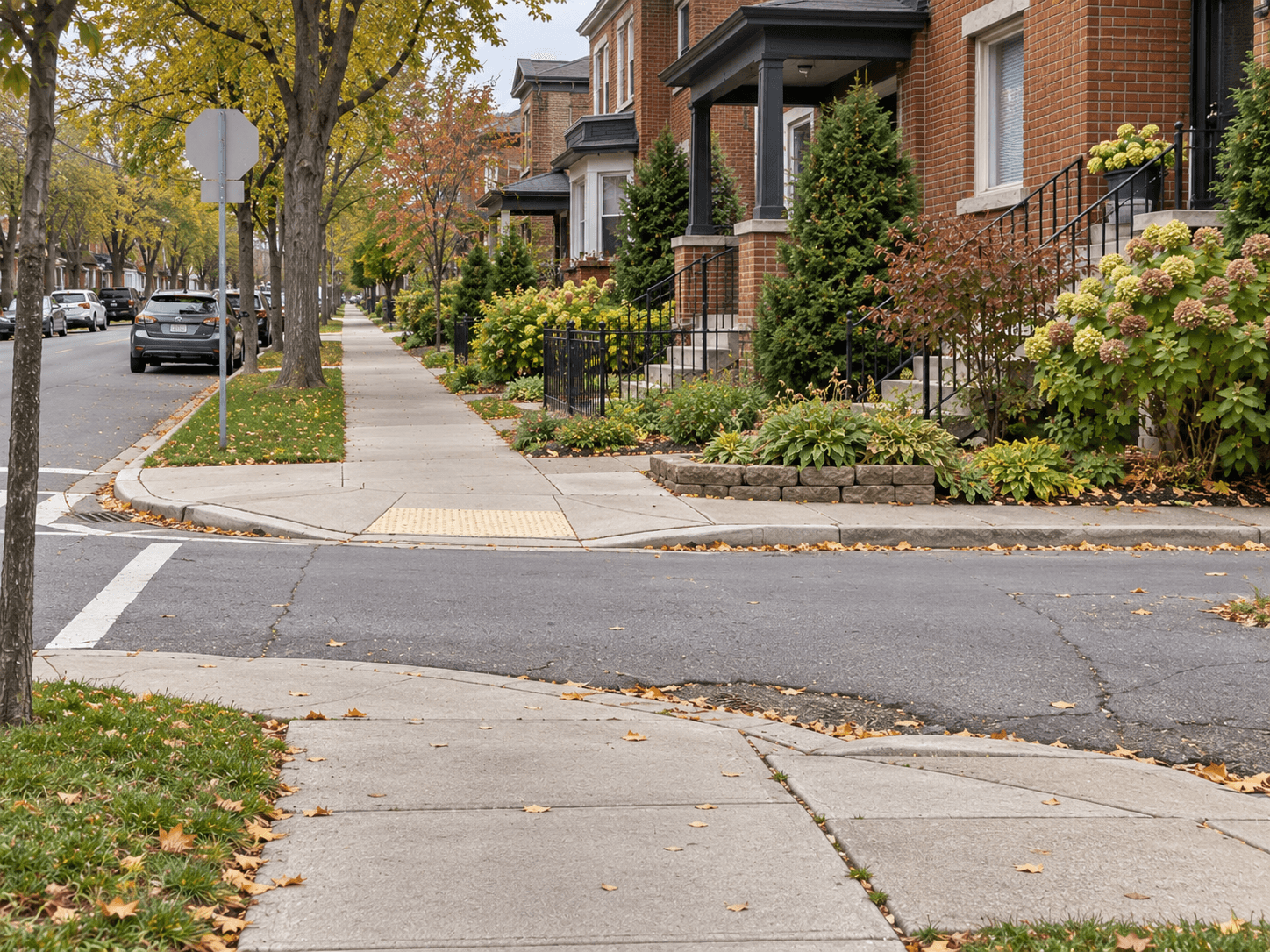 A familiar residential corner with a level pavement continuing back towards nearby houses.