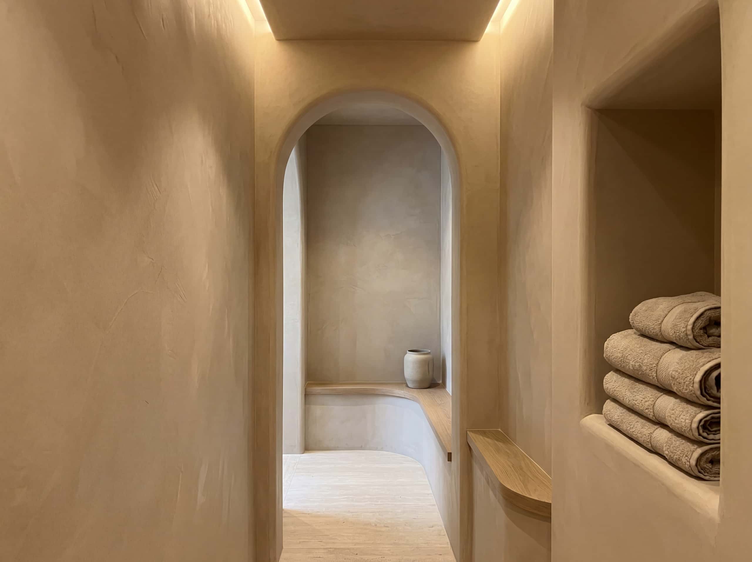 Hallway with arched opening and travertine floor